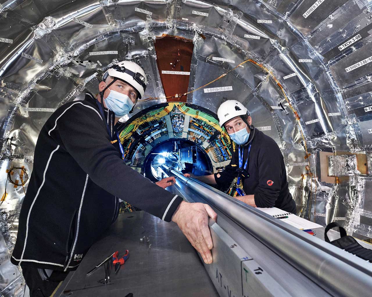 Photo © Maximilien Brice | CERN The CMS jet pipe is being installed.